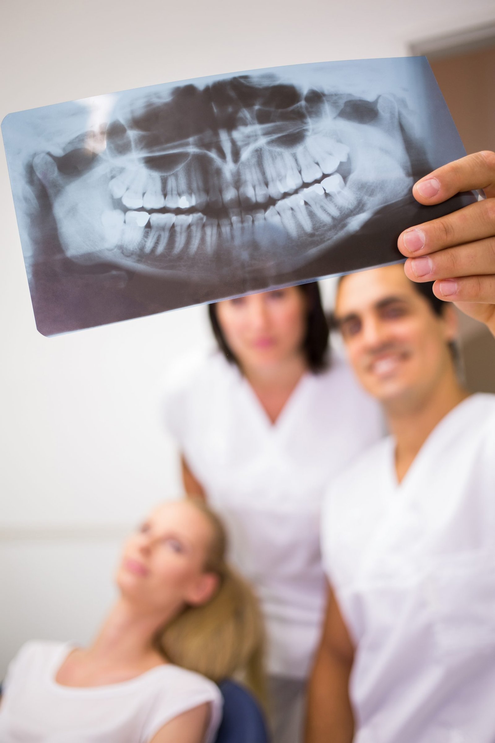 Dentists discussing over dental x-ray report in clinic